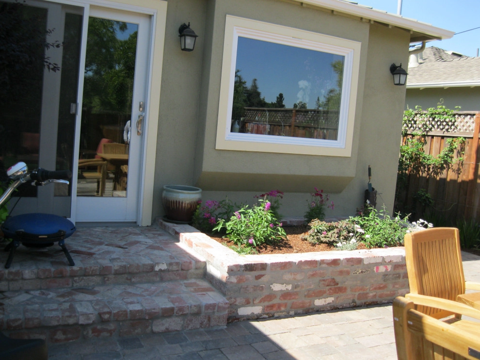 Inviting Garden with Fence, Paved Patio, & Raised Beds by Hortus Design Sustainable Landscapes - Photo 5