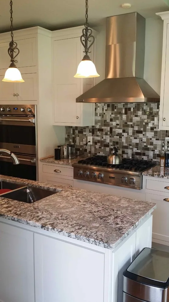Elegant White Shaker Kitchen Featuring Unique Granite by Stoneworld Tn - Photo 2