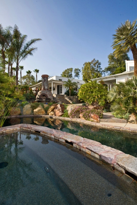 Backyard Landscape Design with Pool, Fireplace, and Custom Stonework by C & H Gardens Artistic Landscape & Tree Service - Photo 13