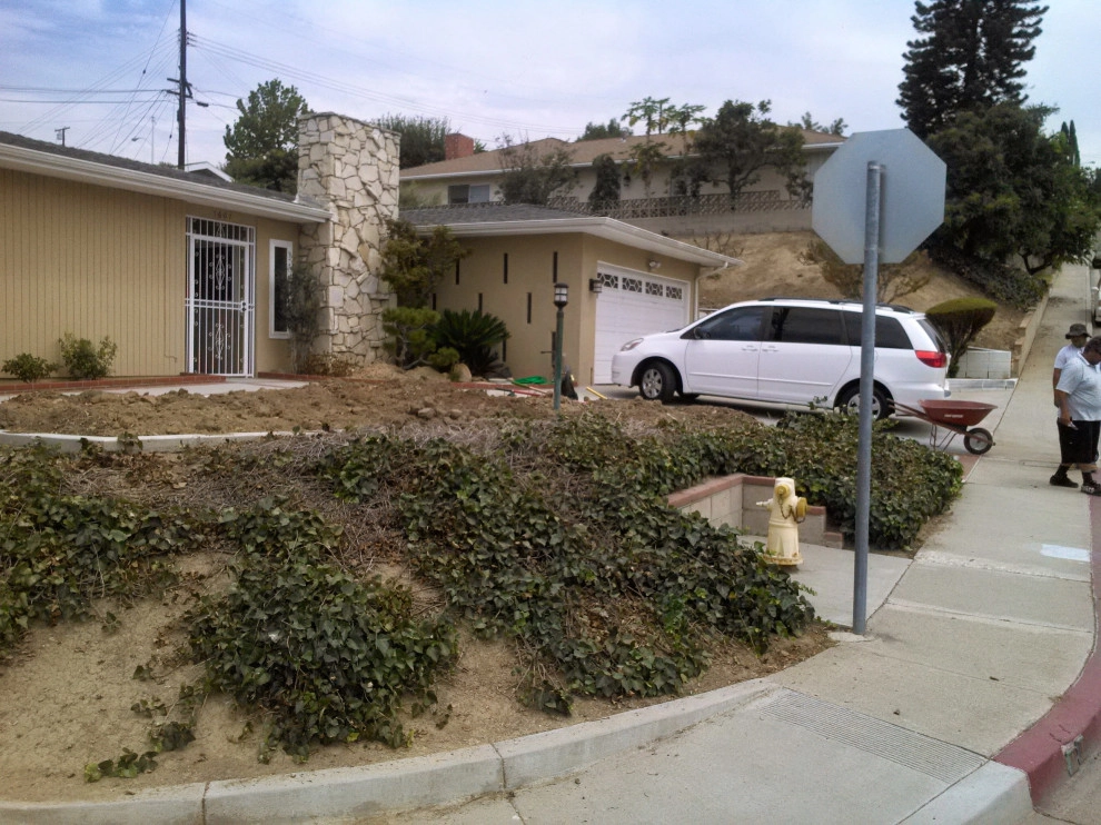 perimeter retaining wall with integrated steps and paver parking area by Natur Landscape Creations - Photo 13