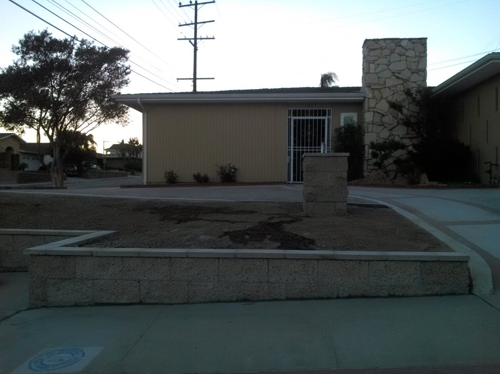 perimeter retaining wall with integrated steps and paver parking area by Natur Landscape Creations - Photo 7