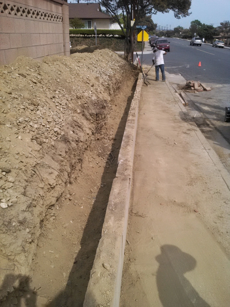 perimeter retaining wall with integrated steps and paver parking area by Natur Landscape Creations - Photo 3