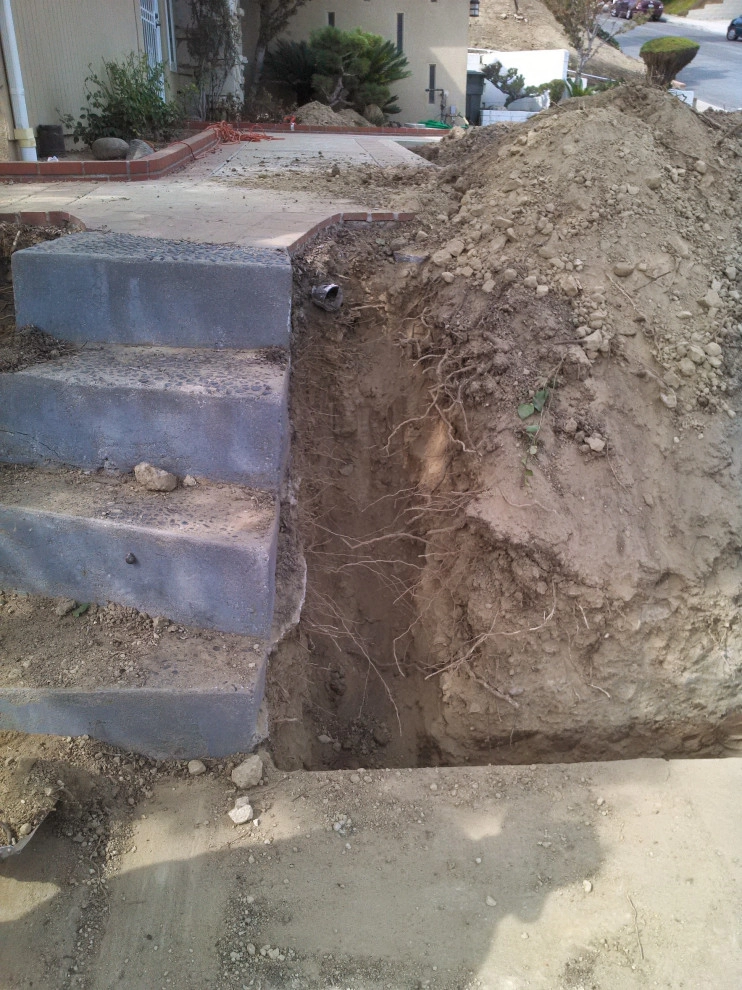 perimeter retaining wall with integrated steps and paver parking area by Natur Landscape Creations - Photo 15