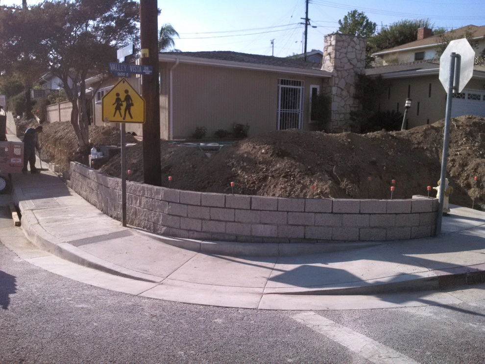 perimeter retaining wall with integrated steps and paver parking area by Natur Landscape Creations - Photo 12