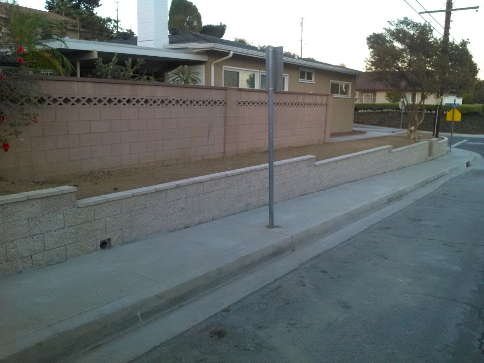 perimeter retaining wall with integrated steps and paver parking area by Natur Landscape Creations - Photo 9