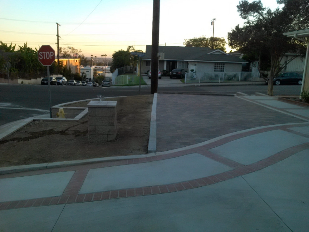 perimeter retaining wall with integrated steps and paver parking area by Natur Landscape Creations - Photo 2