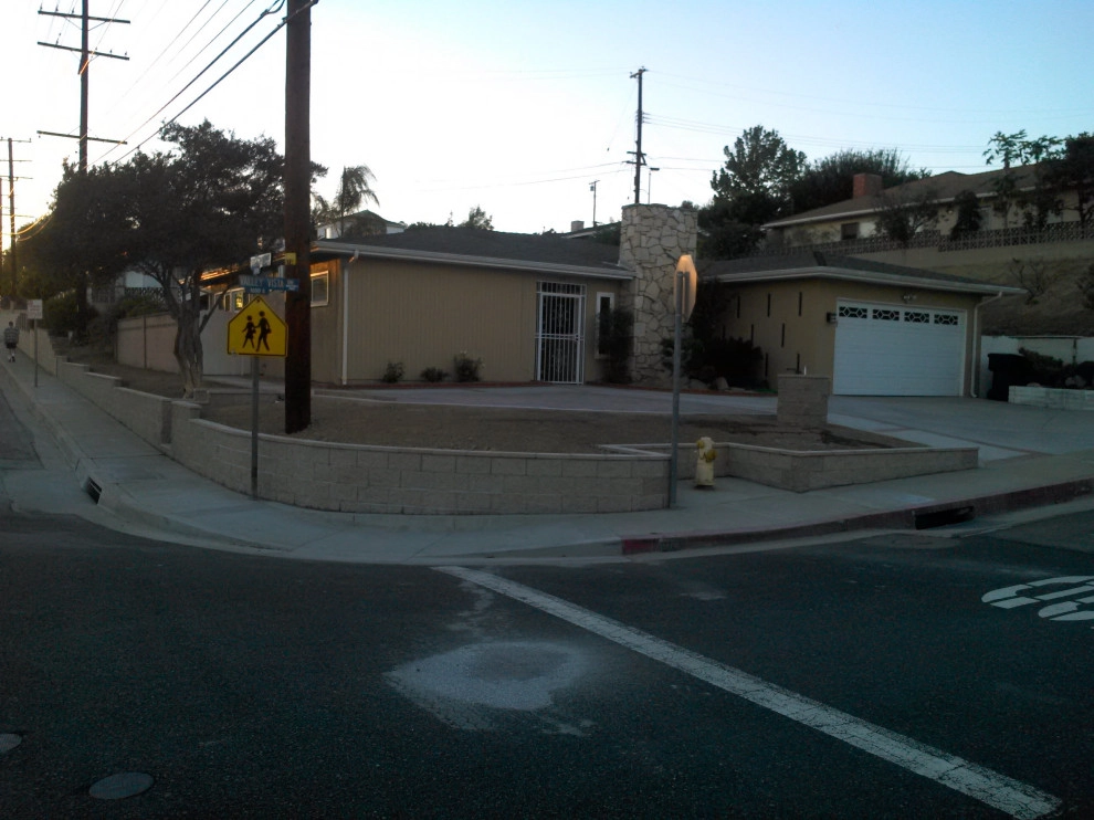 perimeter retaining wall with integrated steps and paver parking area by Natur Landscape Creations - Photo 10