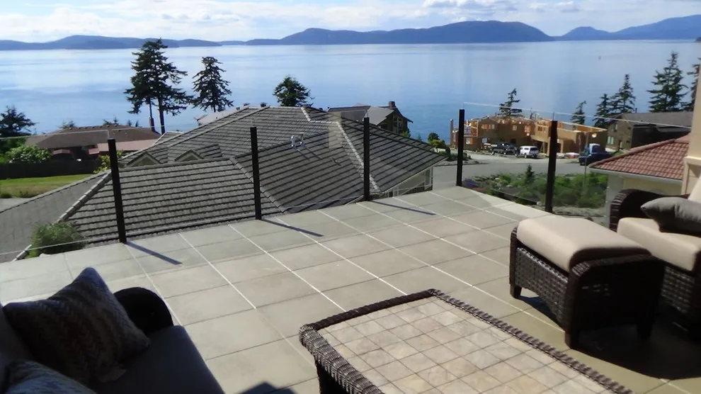 Glass-railed paver deck by Dexperts - Photo 4