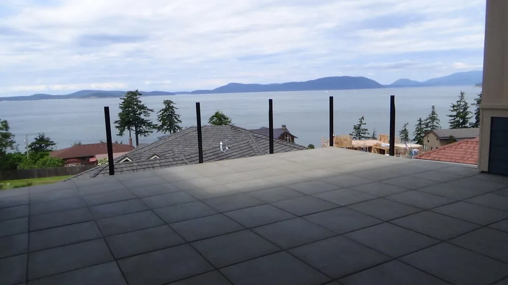 Glass-railed paver deck by Dexperts - Photo 3