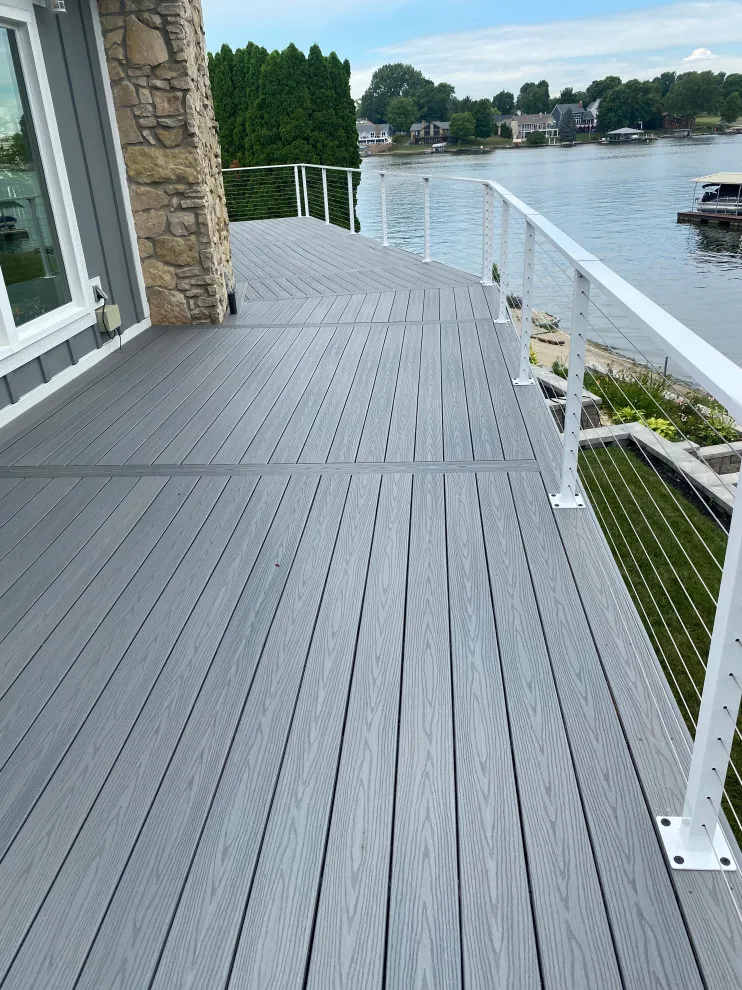 Tiered composite deck with metal railing by DeckThisOut - Photo 6