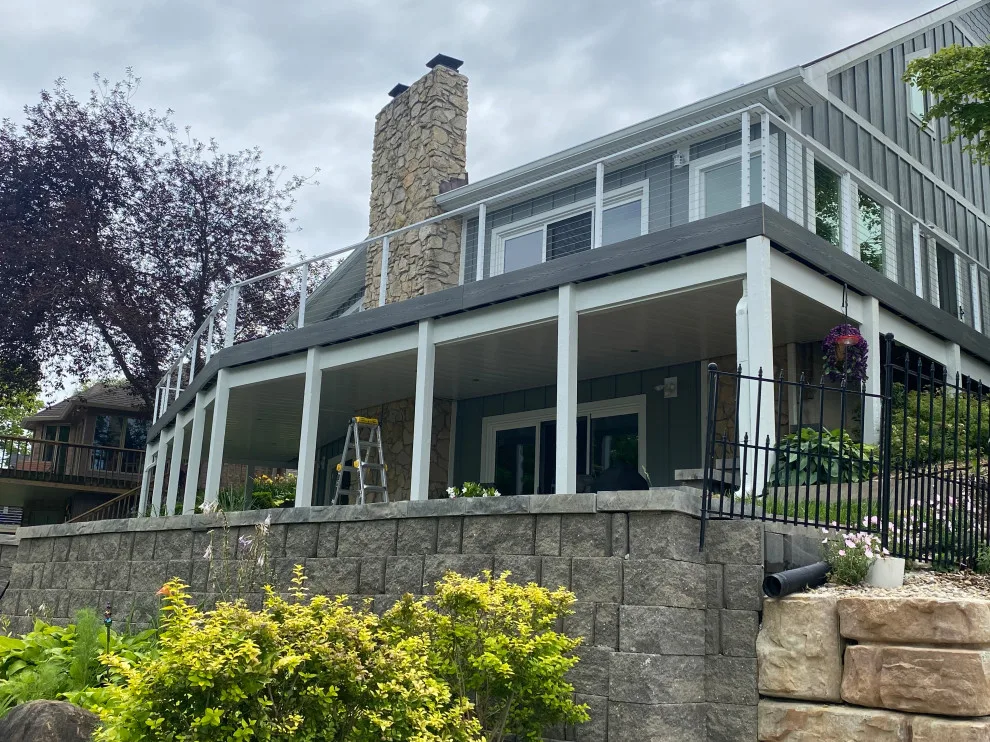 Tiered composite deck with metal railing by DeckThisOut - Photo 5