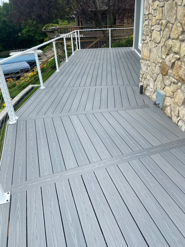 Tiered composite deck with metal railing by DeckThisOut - Photo 3