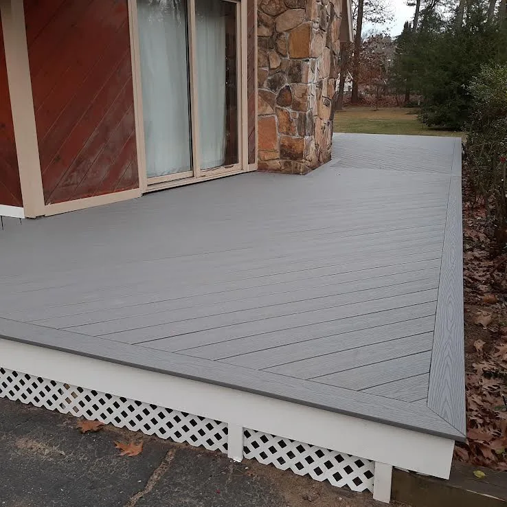 Ground-Level Wraparound Deck with Angled Composite Decking by Dynamic Deck Solutions - Photo 2