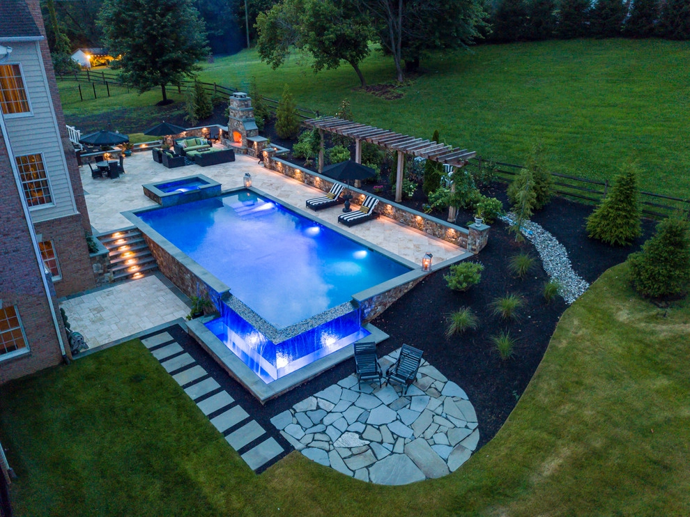 Infinity edge swimming pool, fireplace and travertine patio. by Rock Water Farm - Photo 7