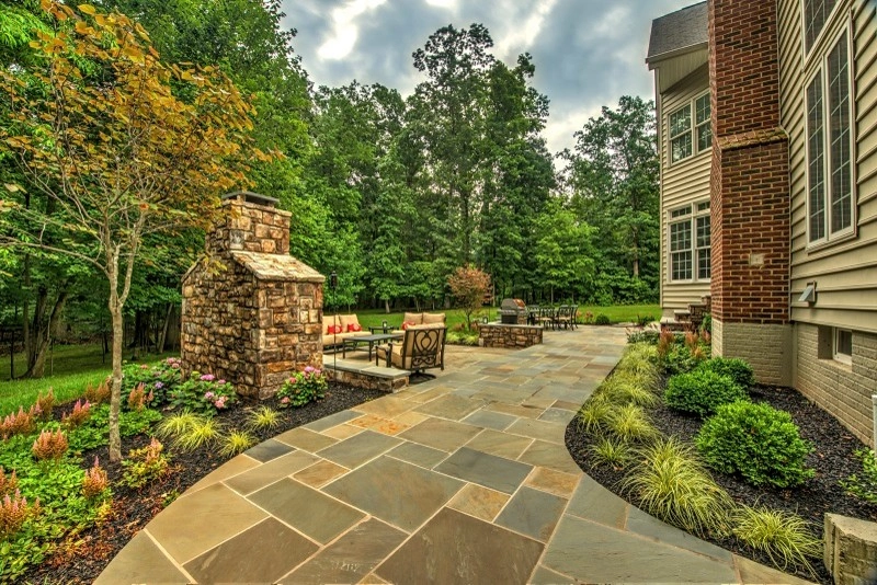 Patio with stone patio & fireplace. by Rock Water Farm - Photo 3
