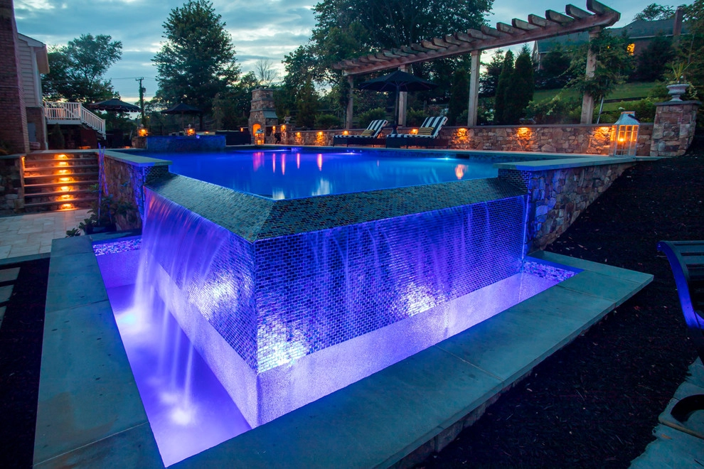 Infinity edge swimming pool, fireplace and travertine patio. by Rock Water Farm - Photo 4