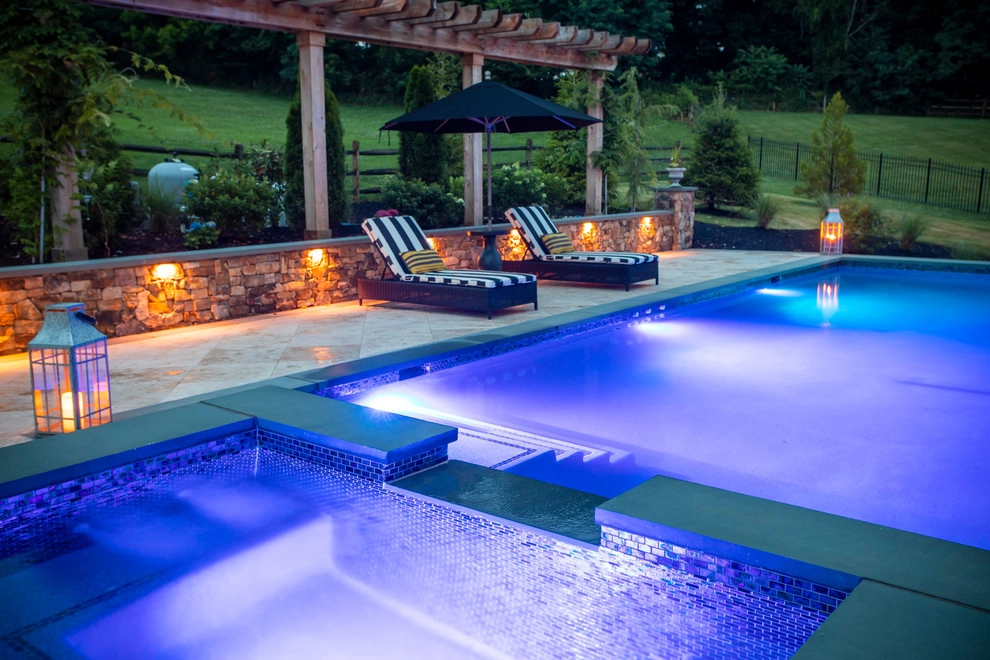 Infinity edge swimming pool, fireplace and travertine patio. by Rock Water Farm - Photo 2