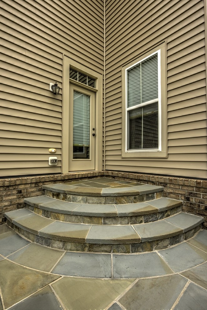 Backyard fireplace with classy curves. by Rock Water Farm - Photo 2