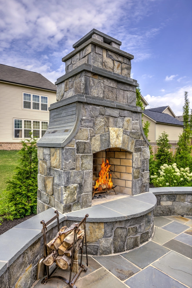 Backyard fireplace with classy curves. by Rock Water Farm - Photo 3