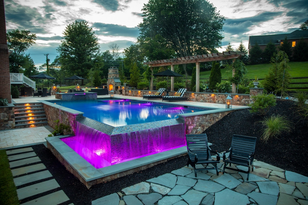 Infinity edge swimming pool, fireplace and travertine patio. by Rock Water Farm - Photo 5