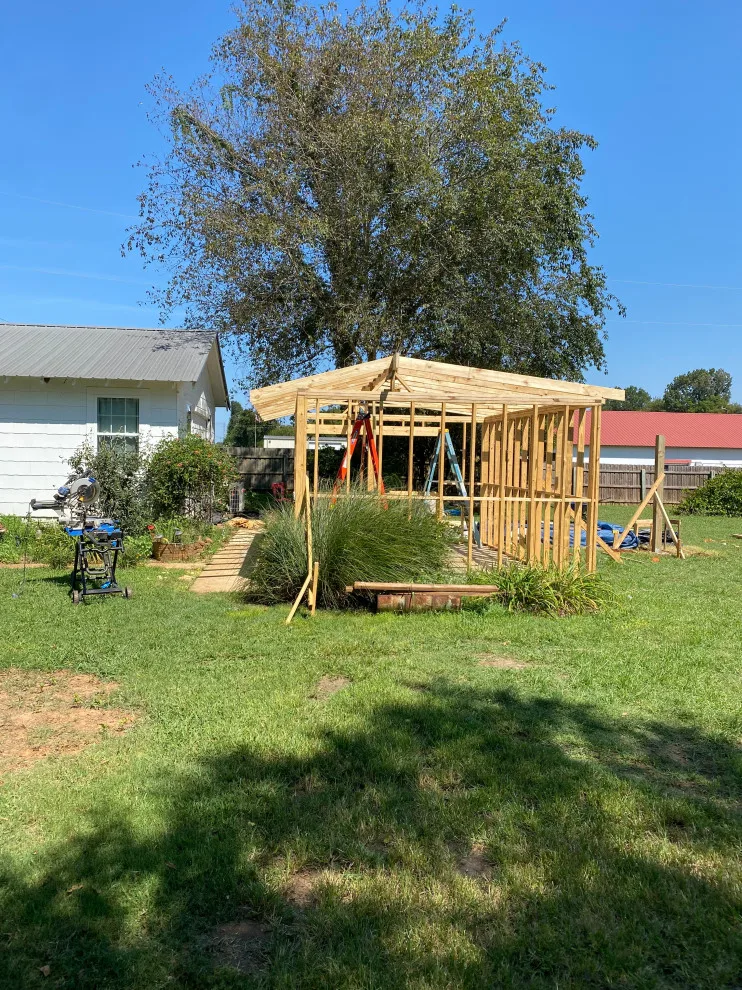 Outdoor cooking area with a lean-to structure by Sims Contracting - Photo 12