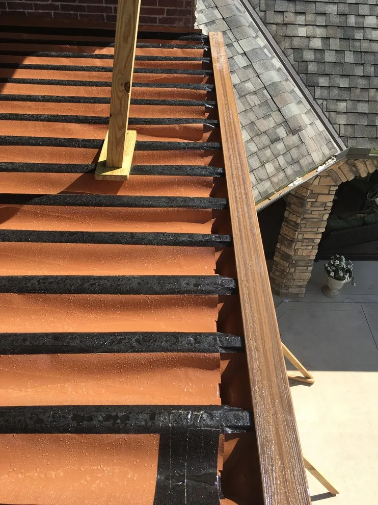 Stunning raised deck featuring Rain Escape for outdoor enjoyment below by Lazo Pro Patios & Decks - Photo 6
