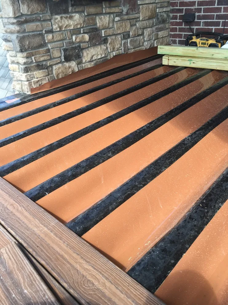 Stunning raised deck featuring Rain Escape for outdoor enjoyment below by Lazo Pro Patios & Decks - Photo 15