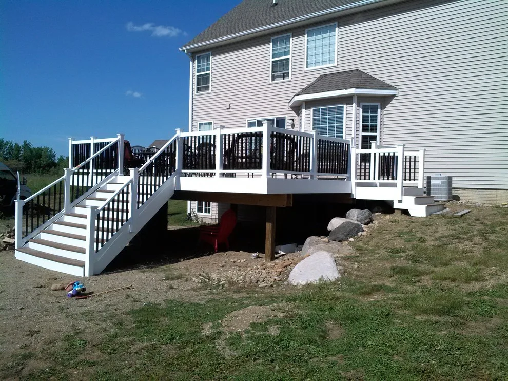 Layered deck with flowing stairs by BKH Development, LLC - Photo 3