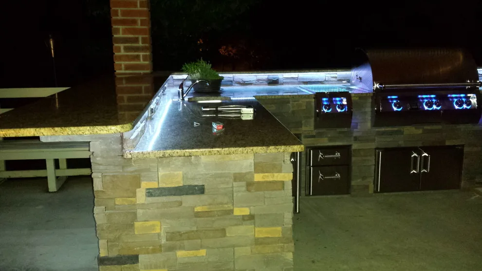 L-Shaped Outdoor Kitchen Featuring Distinctive Lighting by Big Ridge Outdoor Kitchens, LLC - Photo 11