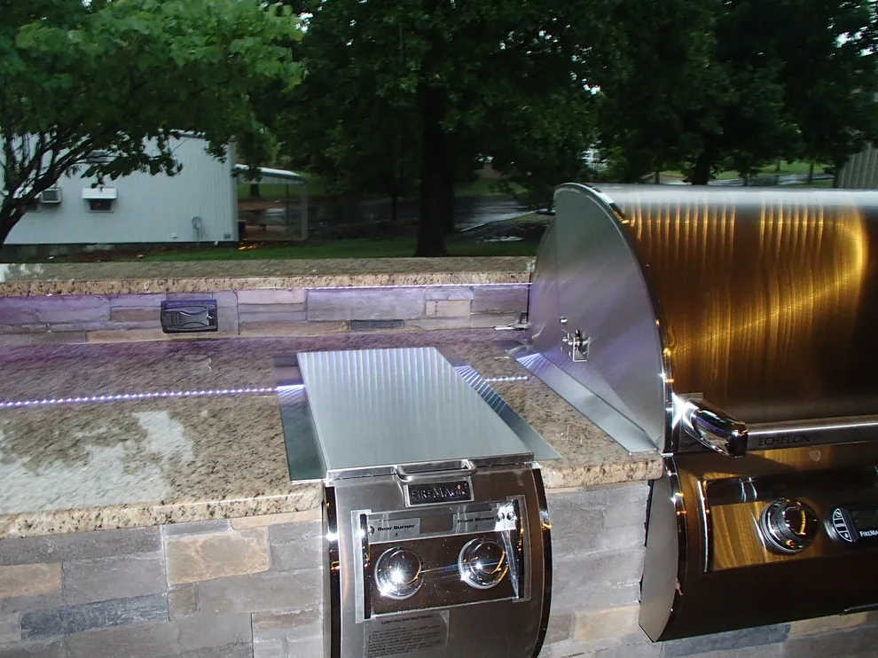 L-Shaped Outdoor Kitchen Featuring Distinctive Lighting by Big Ridge Outdoor Kitchens, LLC - Photo 19