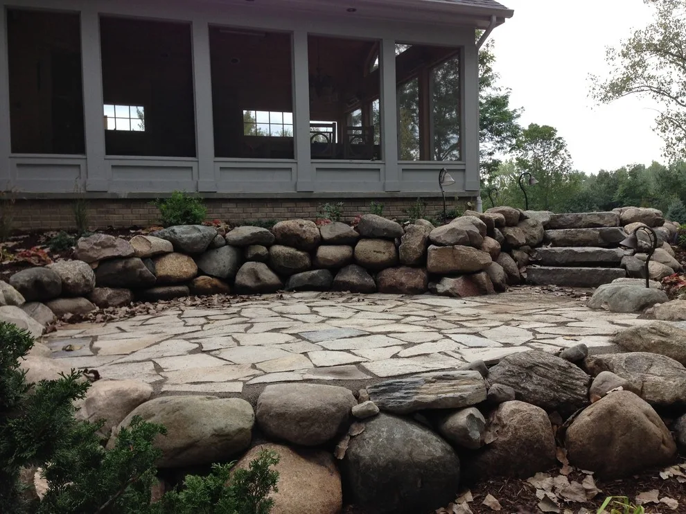 Expanded patio with stone wall by Twin Oaks Landscape, Inc. - Photo 2