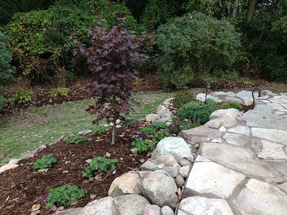 Expanded patio with stone wall by Twin Oaks Landscape, Inc. - Photo 6