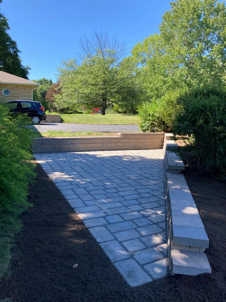 Retaining wall paver patio by Legacy Masonry & Hardscaping - Photo 4