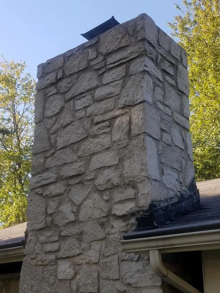 Tuck-pointing stone chimney in Ballwin, Missouri by Masterpiece Masonry - Photo 4