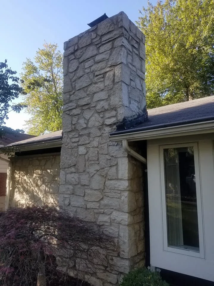 Tuck-pointing stone chimney in Ballwin, Missouri by Masterpiece Masonry - Photo 2