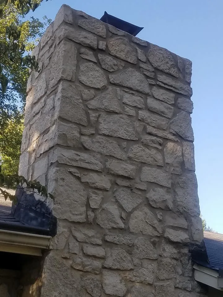 Tuck-pointing stone chimney in Ballwin, Missouri by Masterpiece Masonry - Photo 5