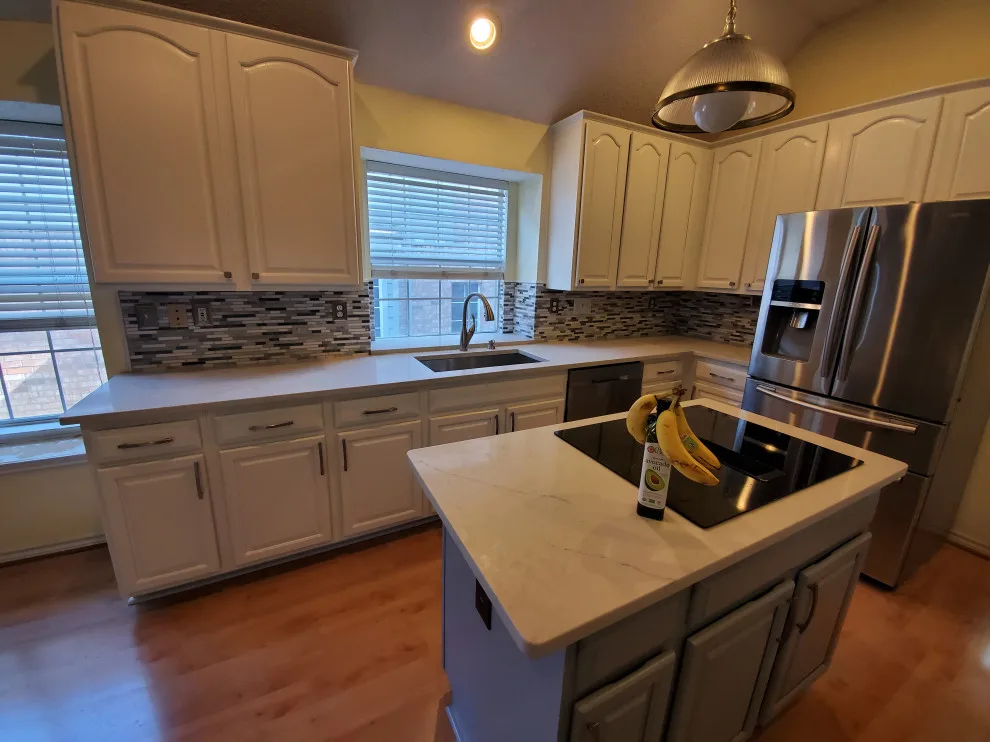Updated kitchen flooring and tile backsplash by Footprints Floors | McKinney - Photo 6