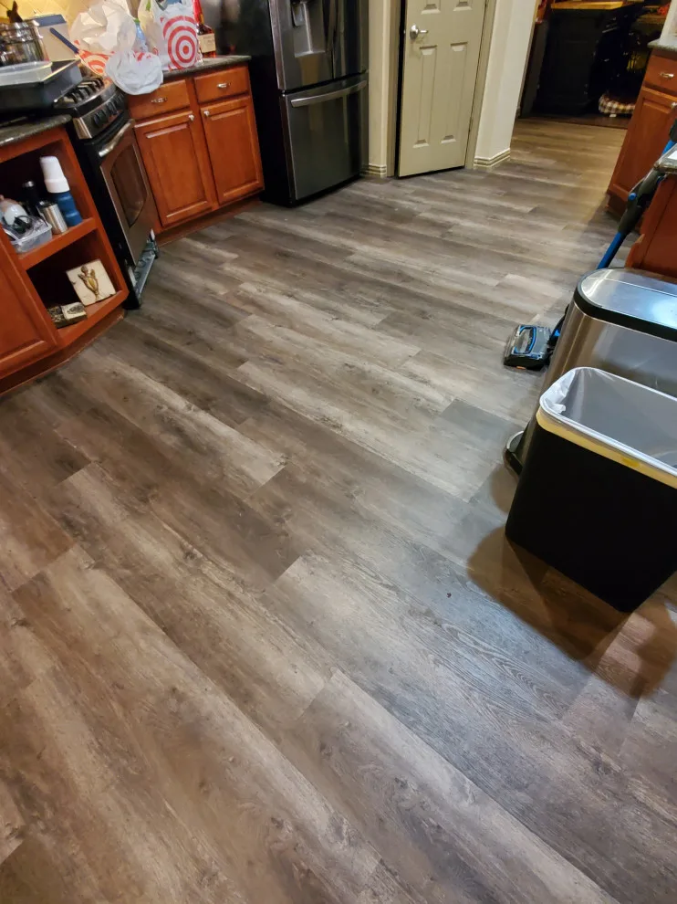 Updated kitchen flooring and tile backsplash by Footprints Floors | McKinney - Photo 13