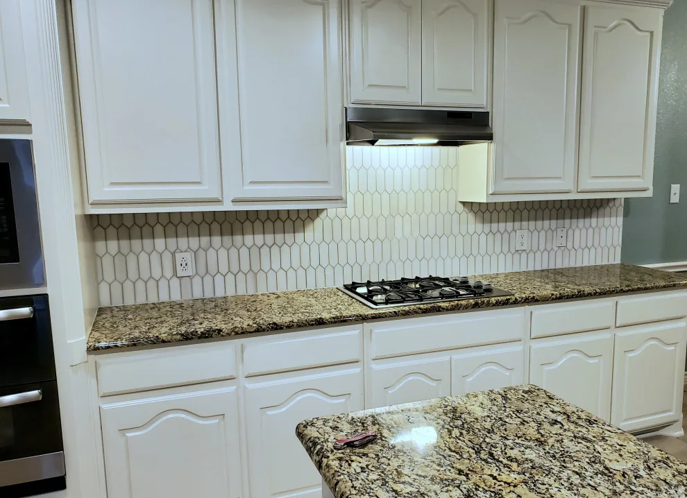 Updated kitchen flooring and tile backsplash by Footprints Floors | McKinney - Photo 8