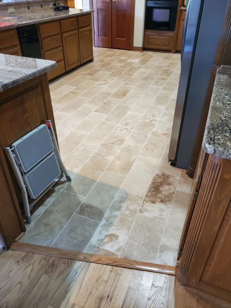 Updated kitchen flooring and tile backsplash by Footprints Floors | McKinney - Photo 7