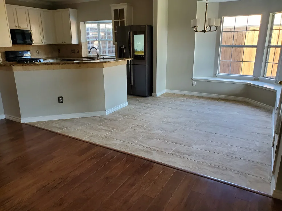 Updated kitchen flooring and tile backsplash by Footprints Floors | McKinney - Photo 4