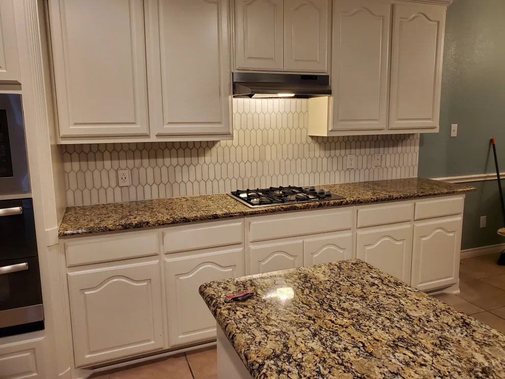 Updated kitchen flooring and tile backsplash by Footprints Floors | McKinney - Photo 12