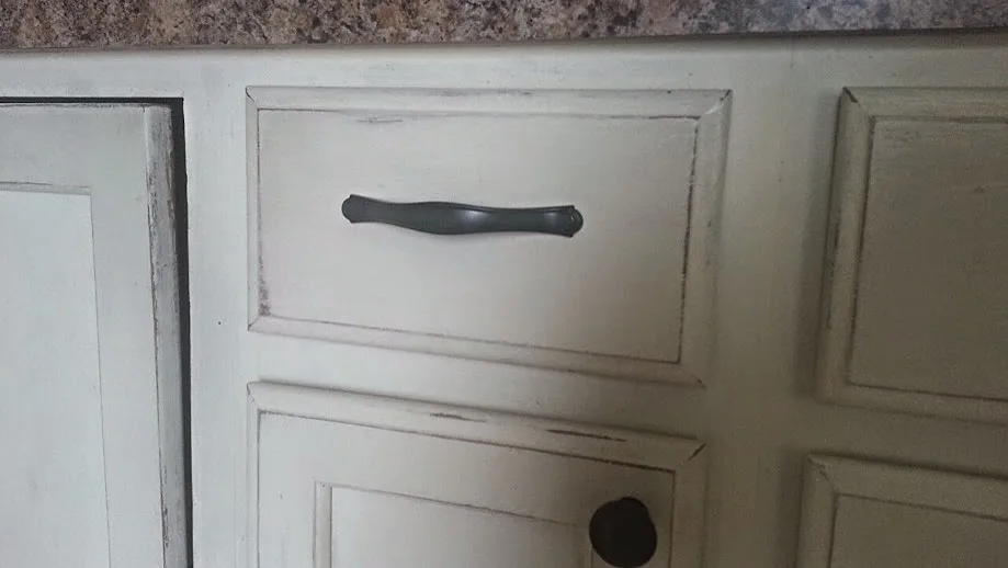 Distressed kitchen cabinets with a painted finish by ValHolla LLC - Photo 5