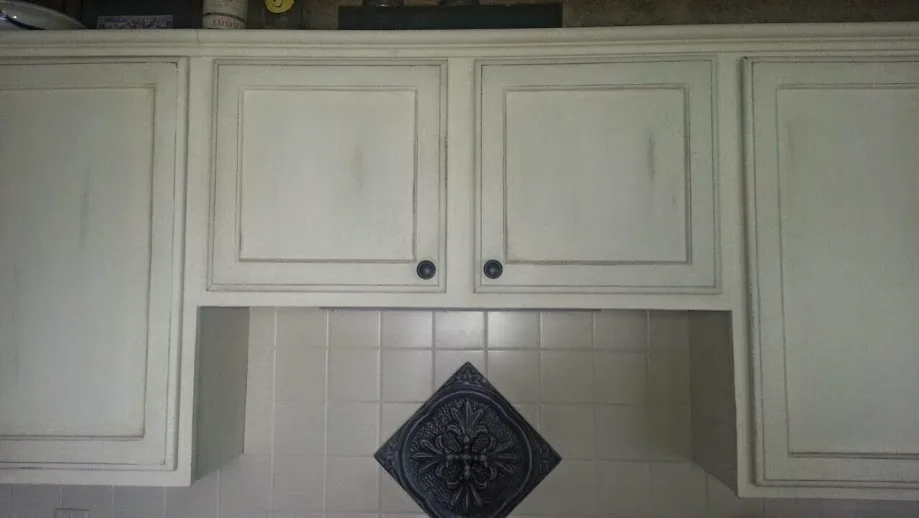 Distressed kitchen cabinets with a painted finish by ValHolla LLC - Photo 3