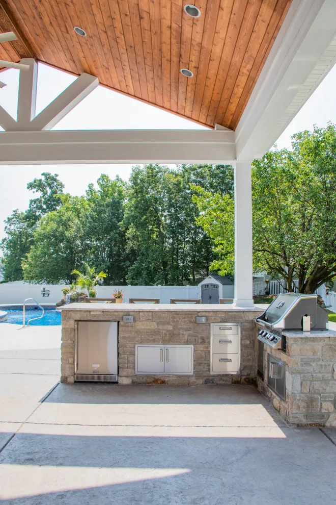 Gabled Pool House Featuring a Fireplace and Grilling Space by Heartlands Building Company - Photo 8