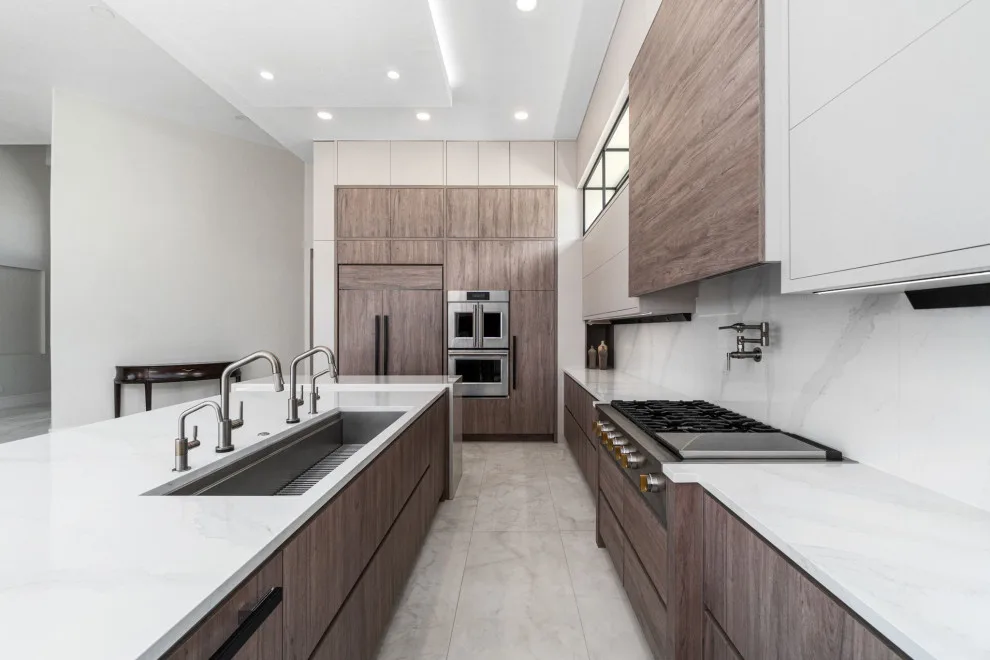 Spacious Modern Two-Tone Kitchen in West Bay by DaVinci Kitchens, Bath, & Cabinetry - Photo 16