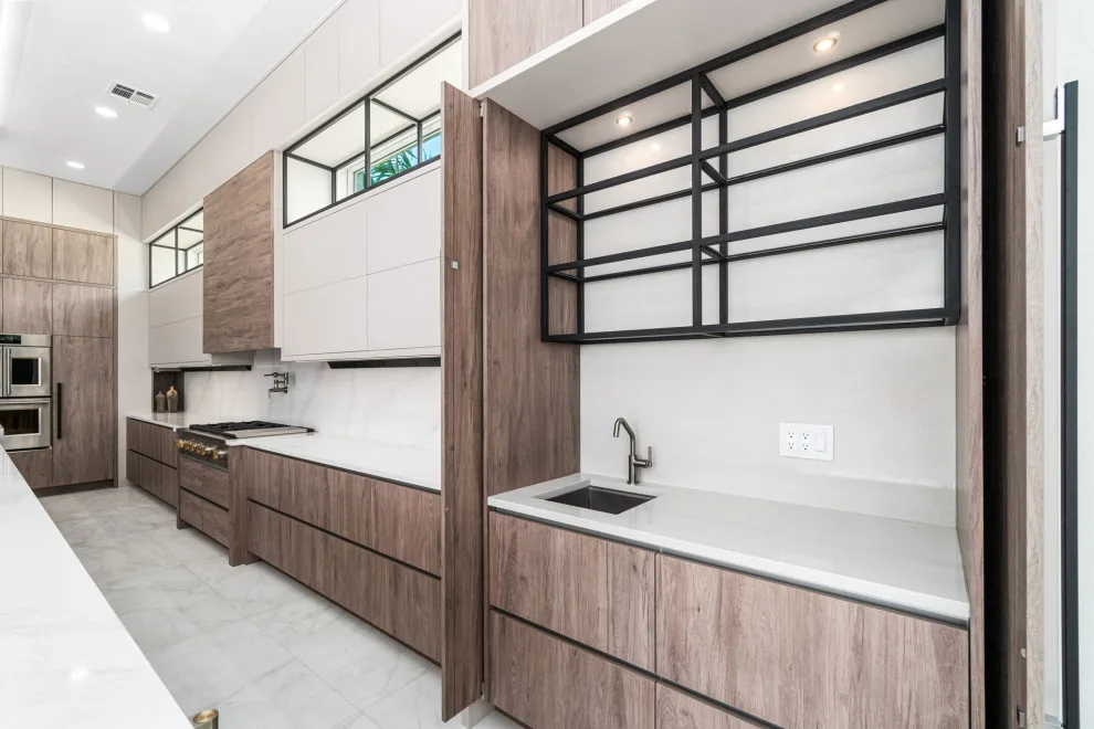 Spacious Modern Two-Tone Kitchen in West Bay by DaVinci Kitchens, Bath, & Cabinetry - Photo 19