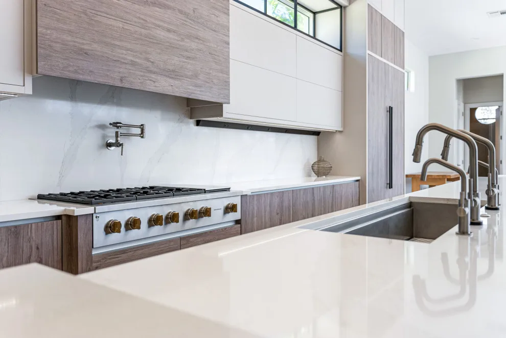 Spacious Modern Two-Tone Kitchen in West Bay by DaVinci Kitchens, Bath, & Cabinetry - Photo 15