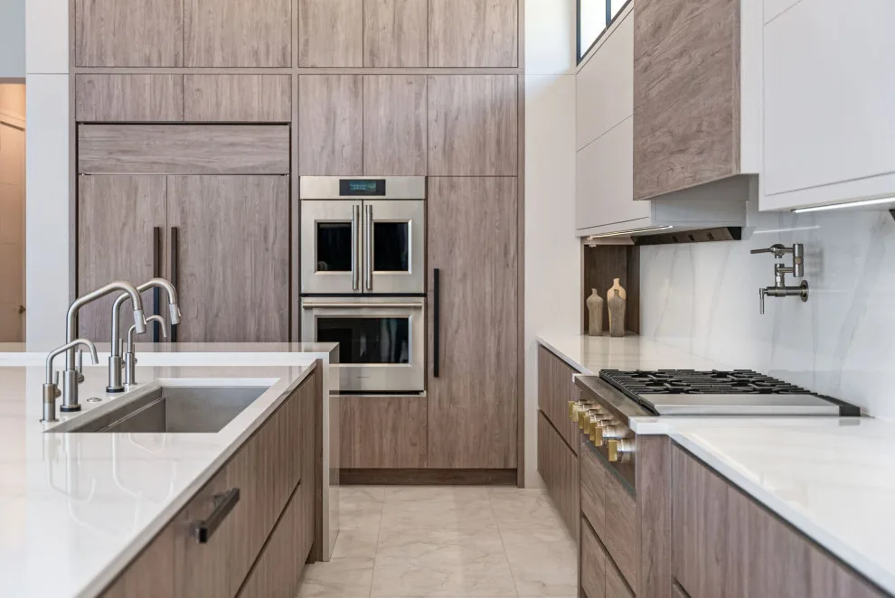 Spacious Modern Two-Tone Kitchen in West Bay by DaVinci Kitchens, Bath, & Cabinetry - Photo 18
