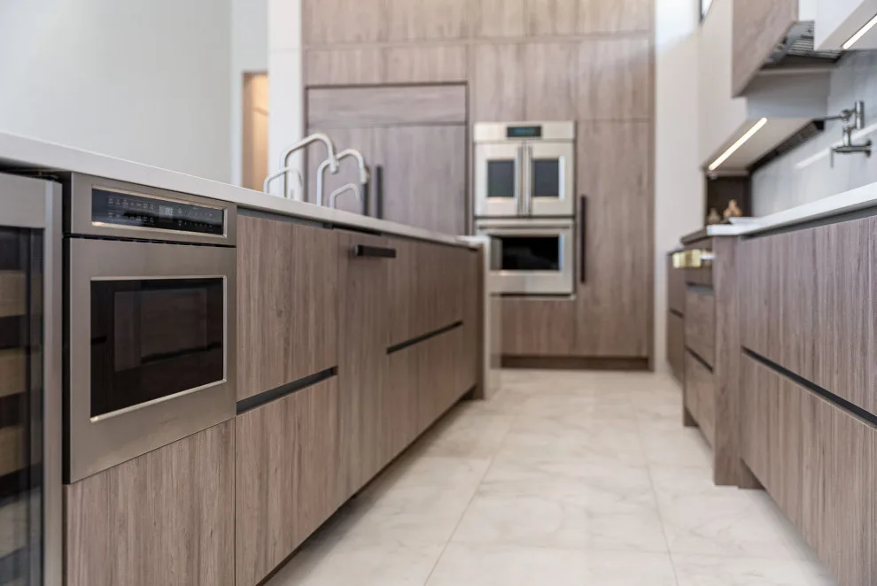 Spacious Modern Two-Tone Kitchen in West Bay by DaVinci Kitchens, Bath, & Cabinetry - Photo 28